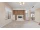 Cozy living room featuring a fireplace, large window, and neutral carpet at 4201 W Renee Dr, Glendale, AZ 85308
