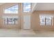 Bright living room featuring tall windows, high ceilings, and neutral-toned walls at 4201 W Renee Dr, Glendale, AZ 85308