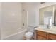 Bright bathroom features a shower-tub combo, toilet and vanity with tile flooring at 42796 W Wild Horse Trl, Maricopa, AZ 85138