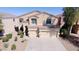 Two-story home featuring a three-car garage, desert landscaping, and a neutral color palette at 42796 W Wild Horse Trl, Maricopa, AZ 85138