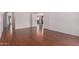 Large living area with wood-look floors and access to other rooms at 42796 W Wild Horse Trl, Maricopa, AZ 85138