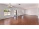 Large living room with wood-look floors, neutral colors, and backyard access at 42796 W Wild Horse Trl, Maricopa, AZ 85138