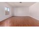 Open concept living area with ample natural light and wood-look flooring at 42796 W Wild Horse Trl, Maricopa, AZ 85138