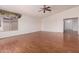 Spacious open floor plan with wood-look floors, bright windows, and neutral paint at 42796 W Wild Horse Trl, Maricopa, AZ 85138