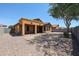 View of the backyard with gravel and fence in good sunlight at 45633 W Mountain View Rd, Maricopa, AZ 85139