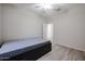 A bright bedroom with neutral walls, ceiling fan and a door leading to other rooms at 45633 W Mountain View Rd, Maricopa, AZ 85139