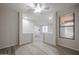 Versatile bonus room with wood-look floors, neutral paint, ceiling fan, and seamless flow into living spaces at 45633 W Mountain View Rd, Maricopa, AZ 85139