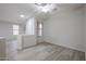 Versatile bonus room featuring wood-look floors, neutral paint, ceiling fan, and natural light from windows at 45633 W Mountain View Rd, Maricopa, AZ 85139