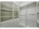 Custom closet featuring white shelving, drawers, and hanging rods for organized storage solutions at 45633 W Mountain View Rd, Maricopa, AZ 85139