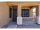 Inviting front porch with neutral paint, security door, and decorative railing for added curb appeal at 45633 W Mountain View Rd, Maricopa, AZ 85139