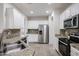 Well-designed kitchen features granite counters, stainless appliances, and plenty of cabinet space for storage at 45633 W Mountain View Rd, Maricopa, AZ 85139