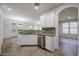 Modern kitchen shows a stainless steel dishwasher, spacious counters, and white cabinetry at 45633 W Mountain View Rd, Maricopa, AZ 85139