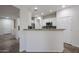 Stylish kitchen features a breakfast bar with granite countertops, stainless steel appliances, and ample cabinets at 45633 W Mountain View Rd, Maricopa, AZ 85139