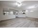 Bright, open living room showcases neutral colors, modern flooring, and seamless flow to kitchen area at 45633 W Mountain View Rd, Maricopa, AZ 85139