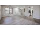 Open-concept living space boasts wood-look floors, neutral paint, and seamless transition to the kitchen area at 45633 W Mountain View Rd, Maricopa, AZ 85139