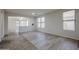 Bright living room featuring wood-look floors, neutral paint, archway, and natural light from multiple windows at 45633 W Mountain View Rd, Maricopa, AZ 85139