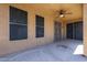Covered patio with ceiling fan, security door, and concrete flooring at 45633 W Mountain View Rd, Maricopa, AZ 85139