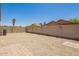 A charming backyard featuring gravel, a block wall, and clear blue skies, making it perfect for outdoor enjoyment at 46123 W Sheridan Rd, Maricopa, AZ 85139