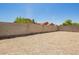 A clean backyard with gravel and block fencing creates a low-maintenance outdoor space at 46123 W Sheridan Rd, Maricopa, AZ 85139