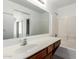 Bright bathroom featuring a large mirror, vanity, and shower-tub combination at 46123 W Sheridan Rd, Maricopa, AZ 85139