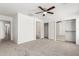 Large bedroom with a ceiling fan, neutral carpet, and walk-in closet at 46123 W Sheridan Rd, Maricopa, AZ 85139