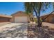 Charming single-story home with a well-maintained front yard and a two-car garage at 46123 W Sheridan Rd, Maricopa, AZ 85139