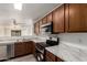 Functional kitchen with stainless steel appliances, marble countertops, and a view into the living area at 46123 W Sheridan Rd, Maricopa, AZ 85139