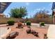 Large backyard showcasing beautiful desert landscaping with rocks and shrubbery at 5215 W Onyx Ave, Glendale, AZ 85302