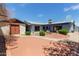Expansive backyard featuring desert landscaping, covered patio, and a separate garage at 5215 W Onyx Ave, Glendale, AZ 85302