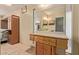Bathroom features a sink vanity with cabinets, mirror, and view into the main bedroom at 5215 W Onyx Ave, Glendale, AZ 85302