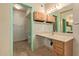 Bathroom featuring a sink, cabinets, toilet, and green trim at 5215 W Onyx Ave, Glendale, AZ 85302
