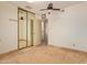Bedroom features a closet with mirrored doors and an open doorway leading to another room at 5215 W Onyx Ave, Glendale, AZ 85302