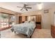 Bedroom featuring built-in shelves and cabinets, ceiling fan, and sliding glass door to the backyard at 5215 W Onyx Ave, Glendale, AZ 85302