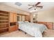 Bedroom featuring a ceiling fan, built-in shelves, and dressers in a home's interior at 5215 W Onyx Ave, Glendale, AZ 85302