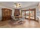 Cozy dining area with a brick fireplace, built-in cabinet, and sliding door to the outside at 5215 W Onyx Ave, Glendale, AZ 85302