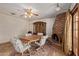 Dining area featuring brick fireplace and adjacent view into the backyard at 5215 W Onyx Ave, Glendale, AZ 85302