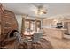 Dining area with brick fireplace, tile floors, adjacent to kitchen with plenty of light at 5215 W Onyx Ave, Glendale, AZ 85302