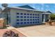Home exterior featuring a large garage door with navy accents and a spacious driveway at 5215 W Onyx Ave, Glendale, AZ 85302