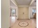 Foyer with detailed tile flooring and a view into living room with arched window at 5215 W Onyx Ave, Glendale, AZ 85302