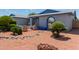 Home featuring a desert landscaped front yard with shrubbery and a gray exterior at 5215 W Onyx Ave, Glendale, AZ 85302