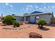 Lovely front yard with bridge accent, desert landscaping, and beautiful curb appeal at 5215 W Onyx Ave, Glendale, AZ 85302