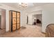 Hallway featuring an ornate cabinet and tile floors with decorative medallion at 5215 W Onyx Ave, Glendale, AZ 85302