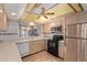 Beautiful kitchen with stainless steel appliances and unique ceiling fan at 5215 W Onyx Ave, Glendale, AZ 85302