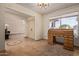 Spacious living room with tile floors, natural light, and vintage desk at 5215 W Onyx Ave, Glendale, AZ 85302