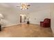 Living room featuring tile floors and a comfortable recliner, illuminated by a ceiling fan at 5215 W Onyx Ave, Glendale, AZ 85302