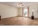 Bright, empty living room featuring tile floors, neutral walls, and large arched window at 5215 W Onyx Ave, Glendale, AZ 85302