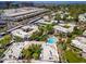 Aerial view of the community and the surrounding neighborhood highlights lush landscaping and a community pool at 5221 N 24Th St # 103, Phoenix, AZ 85016