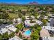 Aerial view showcasing the community pool, golf course, and surrounding lush green neighborhood at 5221 N 24Th St # 103, Phoenix, AZ 85016
