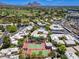 Stunning aerial view of a neighborhood featuring tennis courts, a community pool, and lush green landscaping at 5221 N 24Th St # 103, Phoenix, AZ 85016
