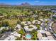 Scenic aerial view captures the community pool, the golf course, and surrounding neighborhood with mountain views at 5221 N 24Th St # 103, Phoenix, AZ 85016